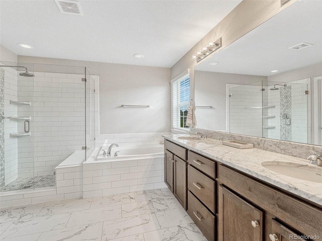 bathroom featuring shower with separate bathtub and vanity