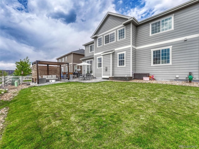 back of house featuring outdoor lounge area, a lawn, and a patio