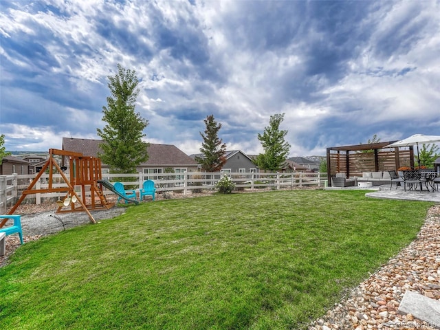 view of yard featuring a playground and a patio area