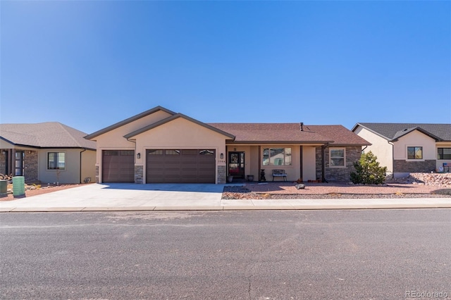 ranch-style home featuring a garage, stone siding, concrete driveway, and stucco siding