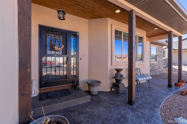 view of exterior entry with stucco siding