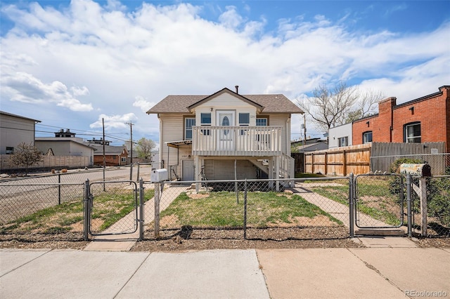view of front of house featuring concrete driveway, a gate, a fenced front yard, and an attached garage