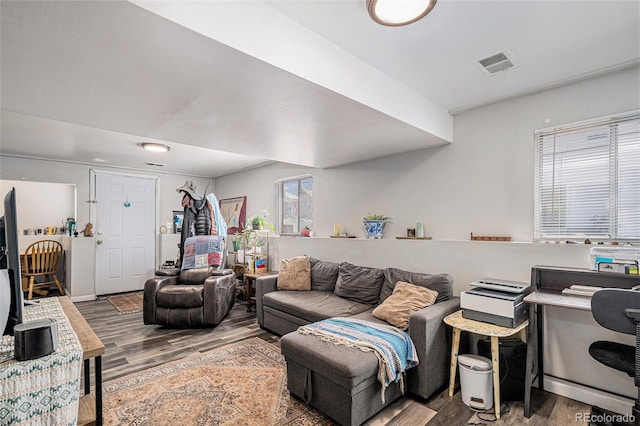 living room with visible vents and wood finished floors
