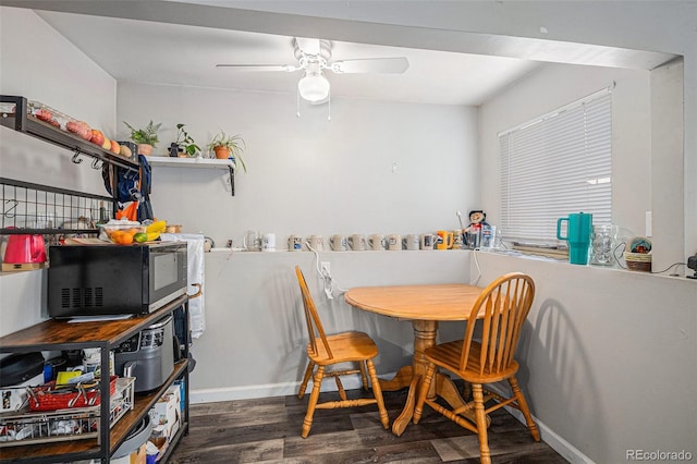 dining room featuring baseboards, ceiling fan, and wood finished floors