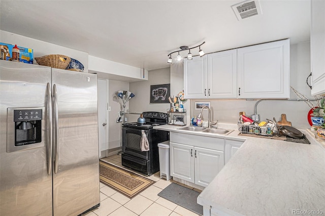 kitchen with a sink, stainless steel fridge with ice dispenser, light tile patterned floors, black range with electric cooktop, and visible vents