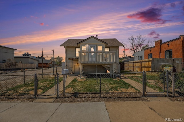 bungalow-style home featuring roof with shingles, a fenced front yard, a garage, stairway, and a gate