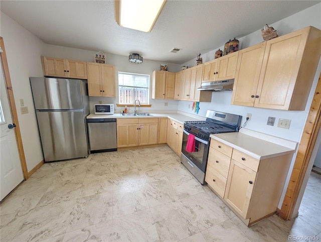240 Fourth St, Fairplay, CO 80440 - kitchen with light brown cabinetry, appliances with stainless steel finishes, under cabinet range hood, a sink, and light countertops