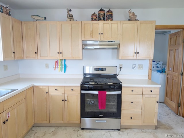240 Fourth St, Fairplay, CO 80440 - kitchen featuring light brown cabinetry, gas stove, under cabinet range hood, washer / dryer, and light marble finish floors