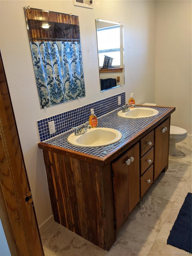 240 Fourth St, Fairplay, CO 80440 - full bath with double vanity, backsplash, and toilet