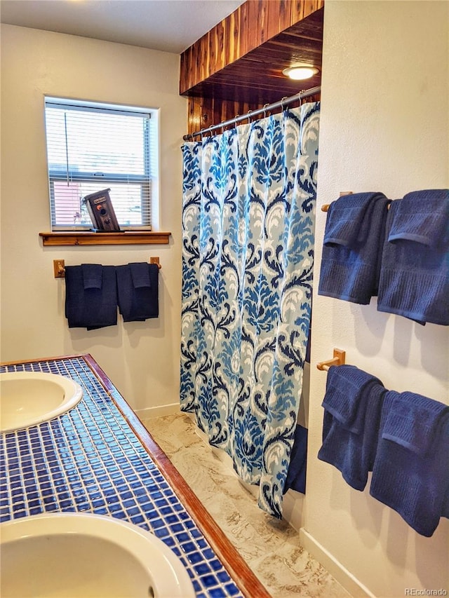 240 Fourth St, Fairplay, CO 80440 - full bathroom with baseboards, a shower with shower curtain, and vanity