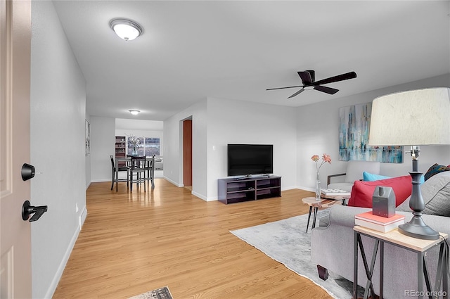 living room with hardwood / wood-style flooring and ceiling fan