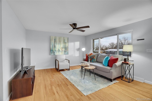 living room featuring ceiling fan and light hardwood / wood-style floors