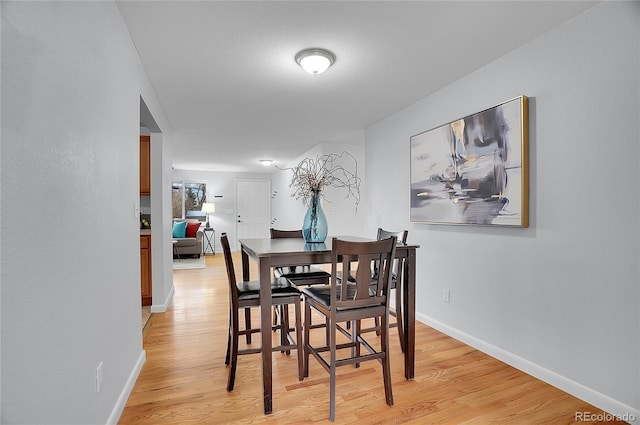 dining space with light hardwood / wood-style flooring