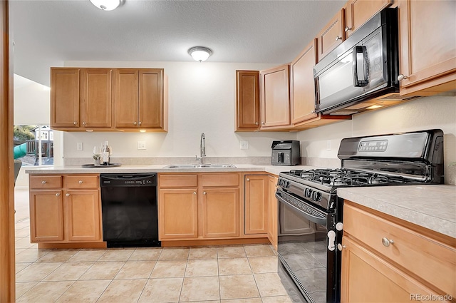 kitchen with black appliances, light tile patterned floors, sink, and a textured ceiling