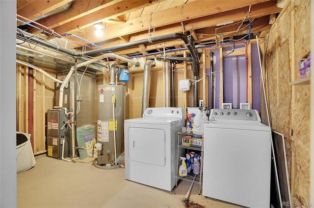 basement with washer and dryer, heating unit, and water heater