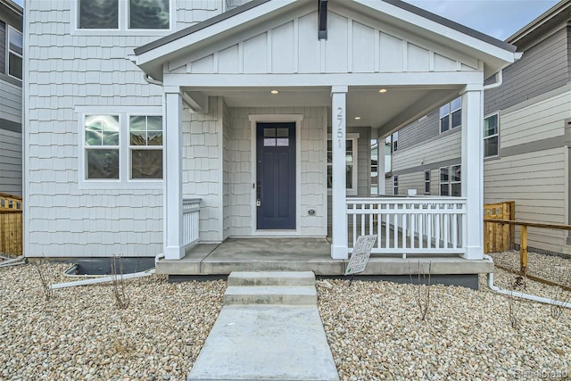 doorway to property featuring covered porch and board and batten siding