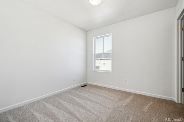 unfurnished room featuring carpet