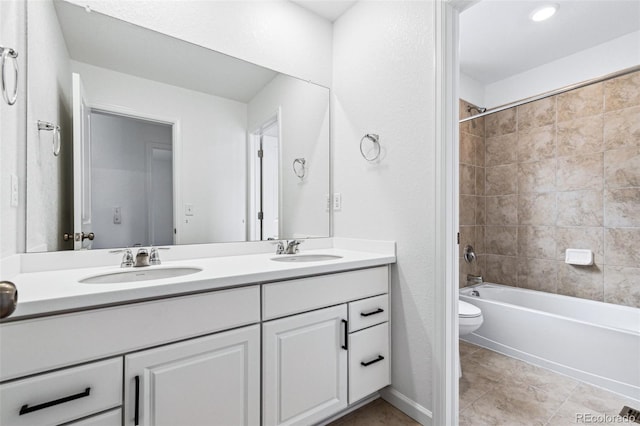 full bathroom with vanity, tiled shower / bath combo, tile patterned floors, and toilet