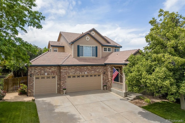 13753 Monroe St, Thornton, CO 80602 - view of front of home with a tile roof, concrete driveway, an attached garage, and brick siding