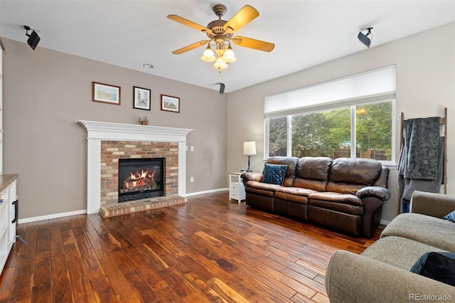 13753 Monroe St, Thornton, CO 80602 - living area with dark wood-style floors, a fireplace, and ceiling fan