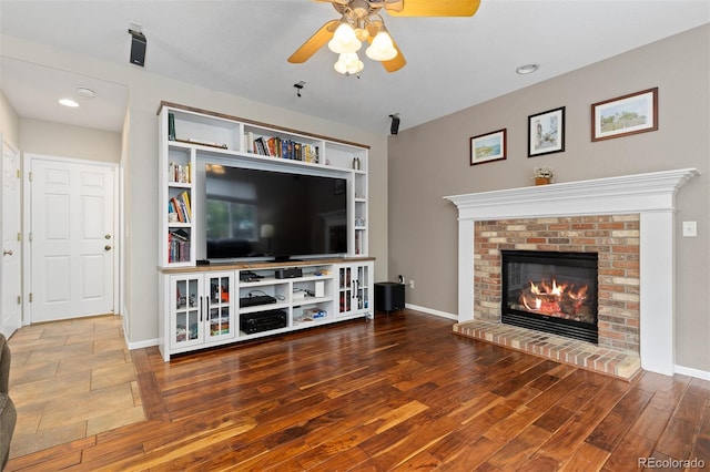 13753 Monroe St, Thornton, CO 80602 - living room with ceiling fan, wood finished floors, a brick fireplace, built in shelves, and recessed lighting
