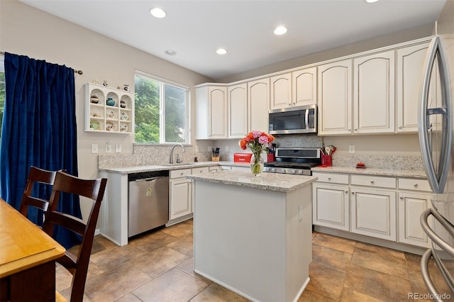 13753 Monroe St, Thornton, CO 80602 - kitchen featuring stainless steel appliances, recessed lighting, white cabinets, a center island, and light stone counters