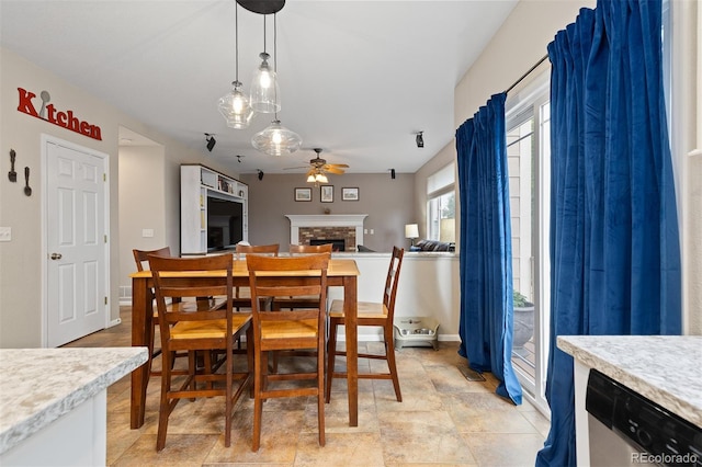 13753 Monroe St, Thornton, CO 80602 - dining area featuring a ceiling fan and a fireplace