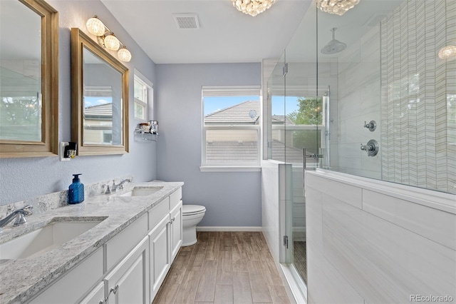 13753 Monroe St, Thornton, CO 80602 - full bath with double vanity, a stall shower, and wood finished floors