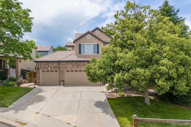 13753 Monroe St, Thornton, CO 80602 - view of front of property featuring driveway, a tiled roof, a front yard, and brick siding