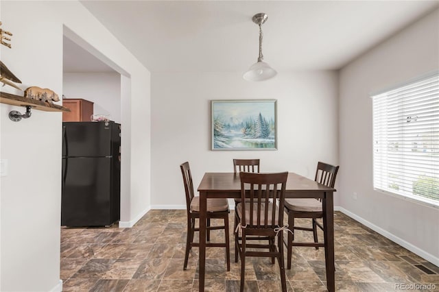 481 Vista Blvd, Brighton, CO 80603 - dining room with stone finish floors, plenty of natural light, and baseboards