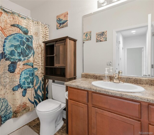 481 Vista Blvd, Brighton, CO 80603 - bathroom featuring toilet, vanity, curtained shower, and tile patterned flooring