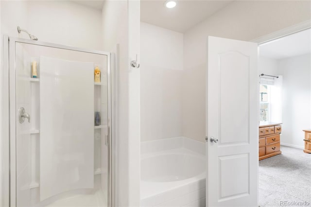 481 Vista Blvd, Brighton, CO 80603 - bathroom featuring a shower stall, a bath, vanity, and baseboards