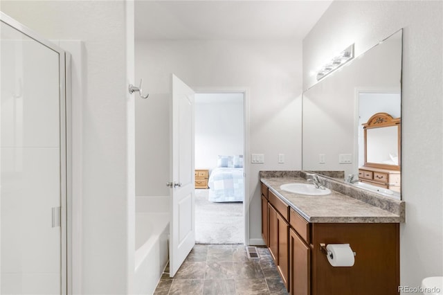 481 Vista Blvd, Brighton, CO 80603 - ensuite bathroom with vanity, a shower, stone finish flooring, and a bath