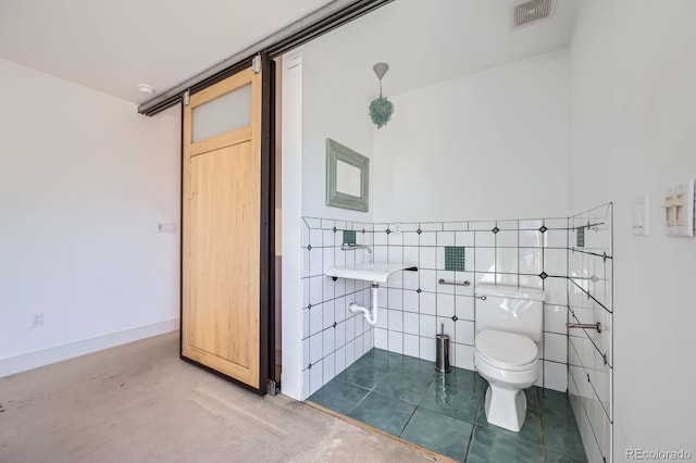 bathroom with toilet, visible vents, tile walls, and tile patterned floors