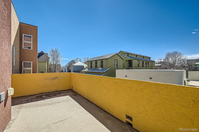 view of patio with a balcony and a residential view