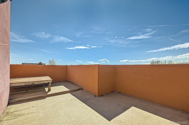 view of patio featuring a balcony