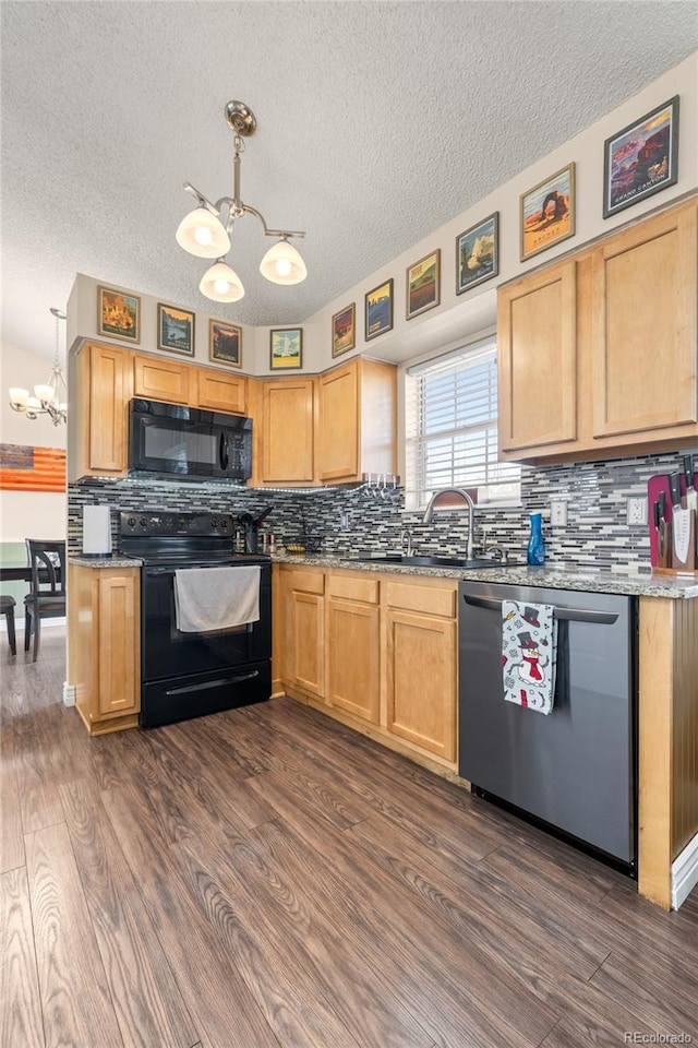 kitchen featuring black appliances, pendant lighting, dark wood-type flooring, and tasteful backsplash