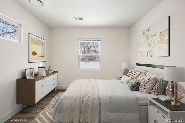 bedroom with dark hardwood / wood-style flooring