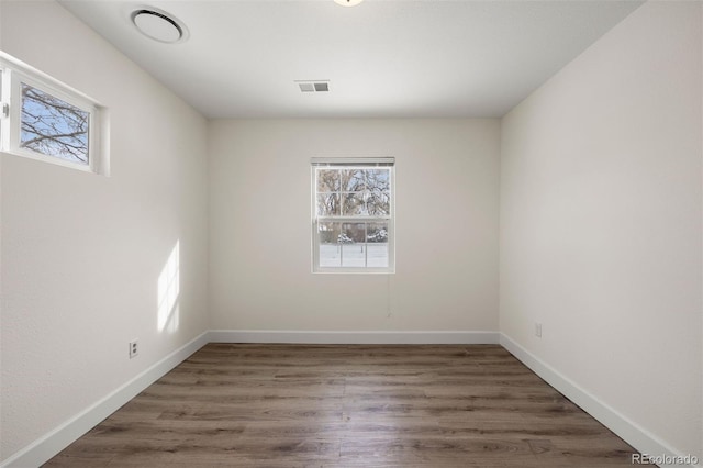 spare room with dark hardwood / wood-style flooring