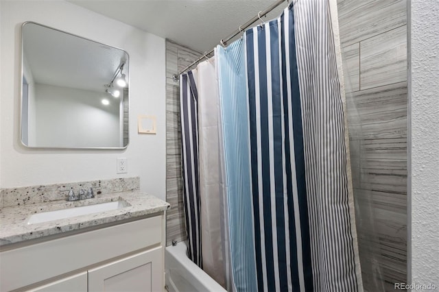 bathroom featuring a textured ceiling and vanity