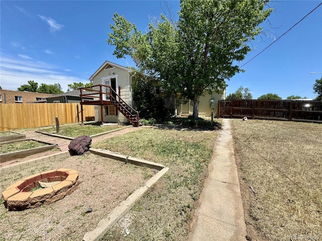 1901 Clinton St, Aurora, CO 80010 - view of yard featuring a fire pit and stairs