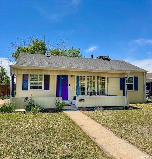 1901 Clinton St, Aurora, CO 80010 - view of front of property featuring a front yard, a porch, and roof with shingles