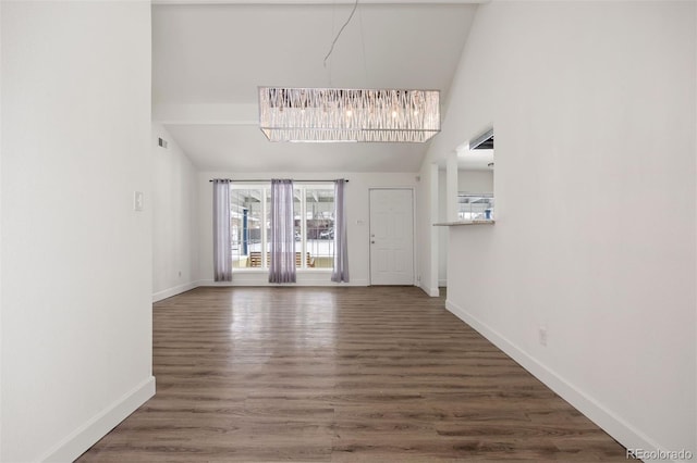 1901 Clinton St, Aurora, CO 80010 - unfurnished living room with baseboards, lofted ceiling, and wood finished floors