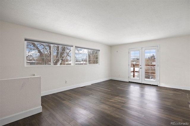 1901 Clinton St, Aurora, CO 80010 - spare room with baseboards, wood finished floors, and a textured ceiling