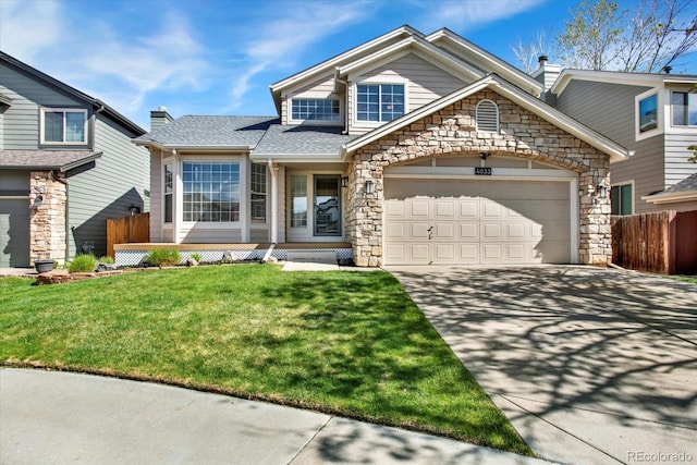 craftsman inspired home featuring stone siding, driveway, fence, and an attached garage