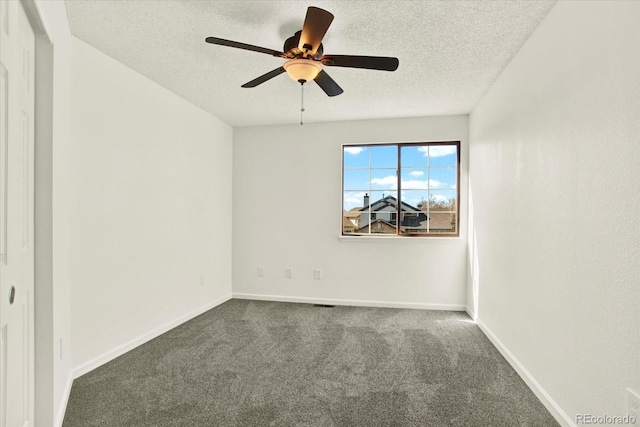 carpeted empty room with a textured ceiling, baseboards, and a ceiling fan
