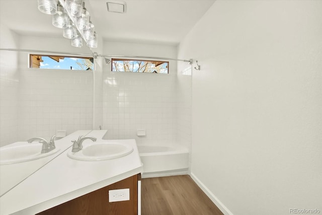 full bathroom with baseboards, vanity, shower / washtub combination, and wood finished floors
