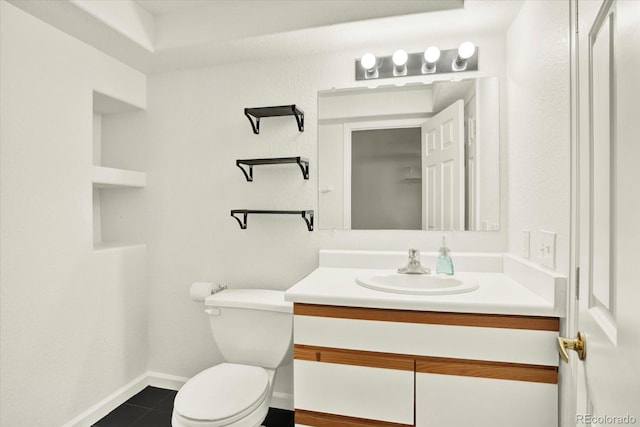 half bath with toilet, baseboards, tile patterned floors, and vanity