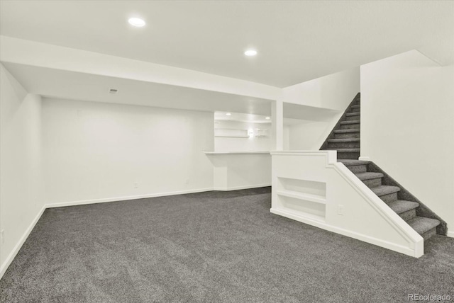 walk in closet with dark colored carpet