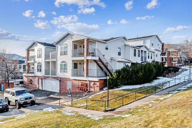 view of property with a balcony and a garage